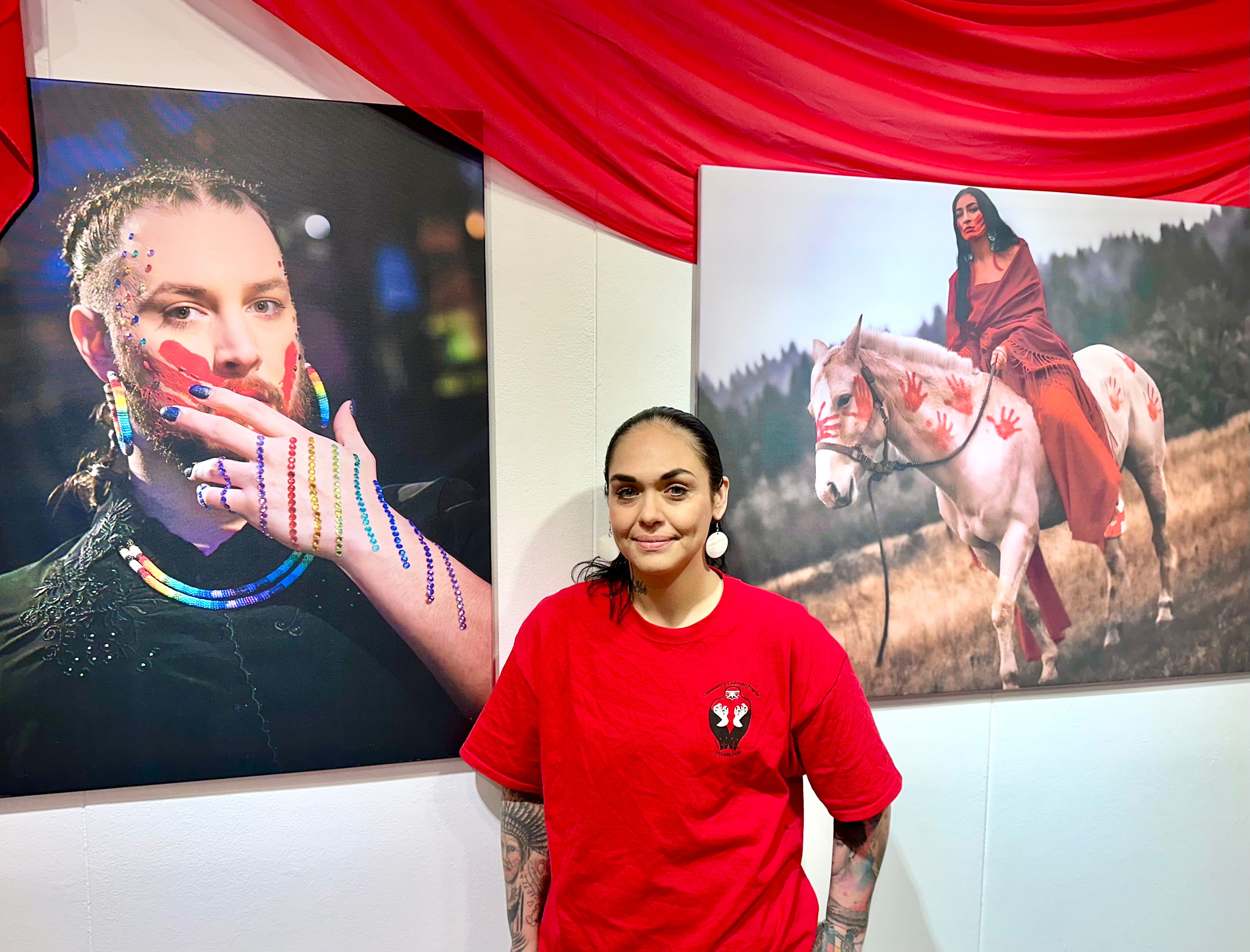 Photographer Amanda Freeman stands in front of two portraits of Natives affected by MMIP, Wednesday, Jan. 14, Salem, Oregon. Freeman’s work will be featured at the Gretchen Schuette Art Gallery until Feb. 6. (Buffalo’s Fire/Brian Bull)