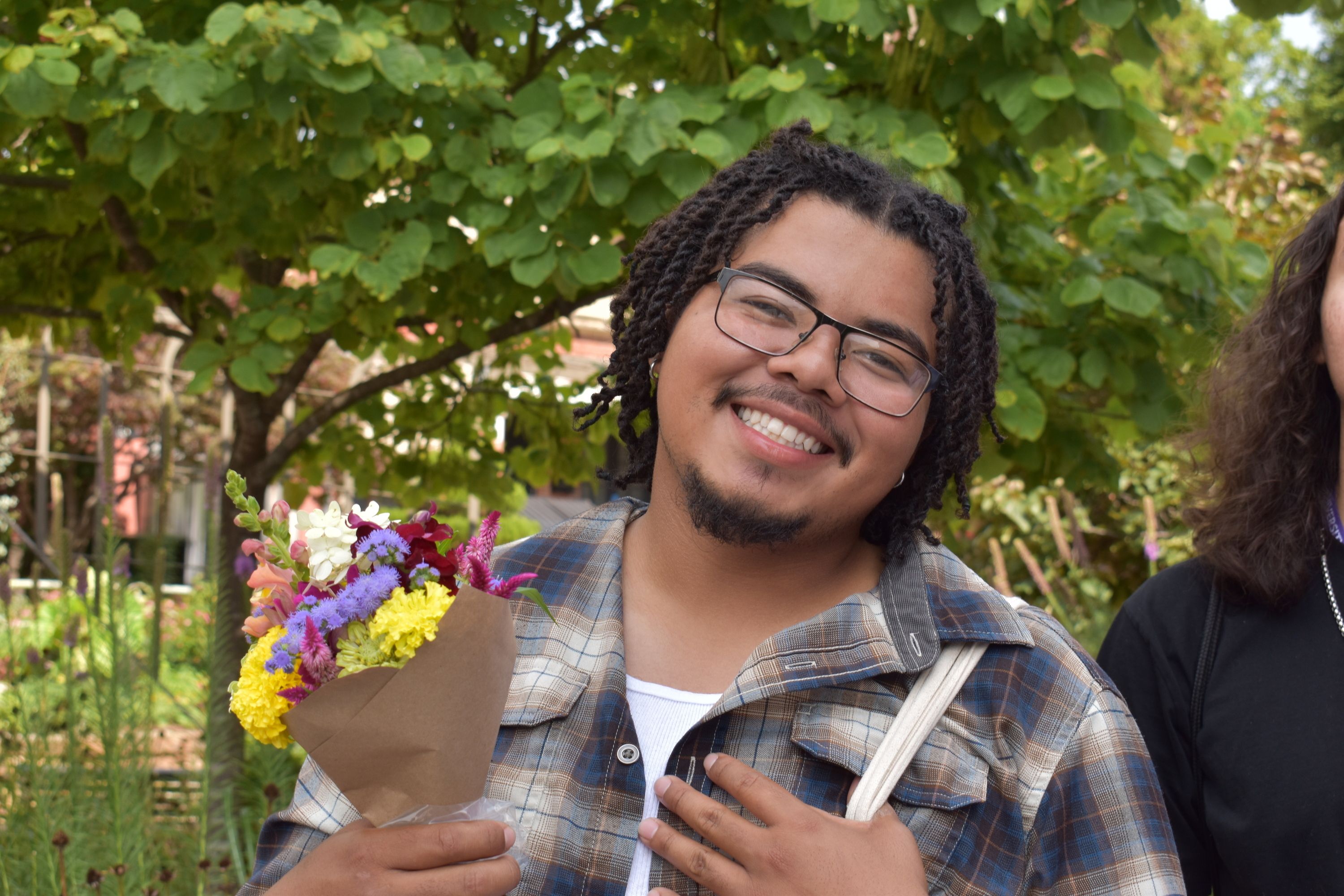 Summit attendee, Chris Aguilar (San Felipe Pueblo), enjoys the Fayetteville Farmer's Market as part of the 2024 Native Youth in Food and Agriculture Leadership Summit. Photo by Arvcuken Noquisi