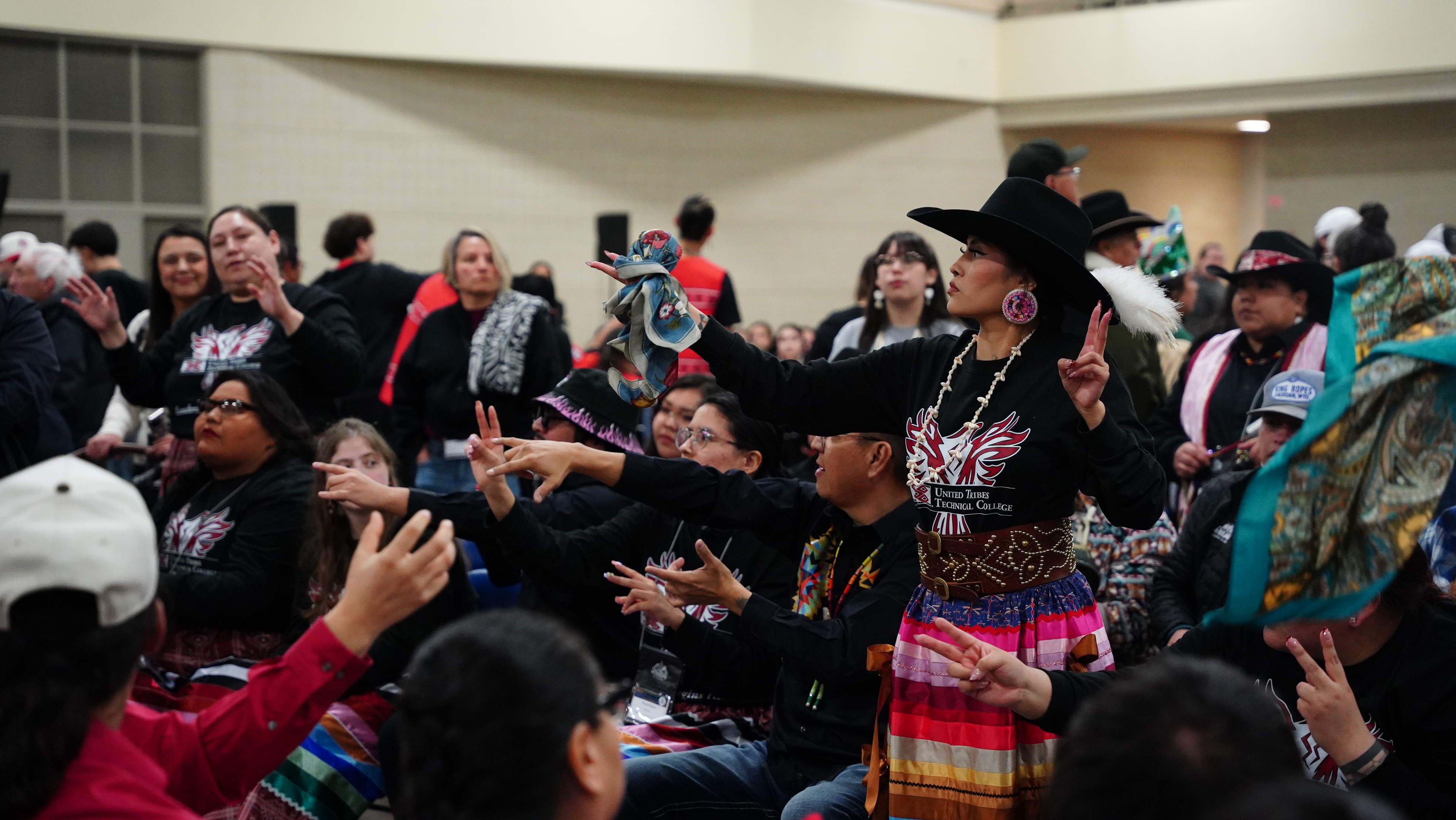 Rattle shaking, singing and bluffing: Hand game matches draw crowds at AIHEC conference