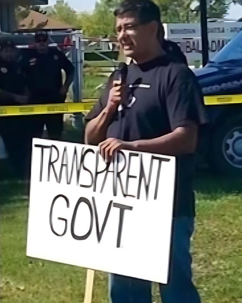 In 2014, Mark Fox holds a tribal government transparency sign as he campaigns outside the Mandan, Hidatsa and Arikara Nation tribal administration building in New Town, North Dakota. It was his first tribal chairman campaign.