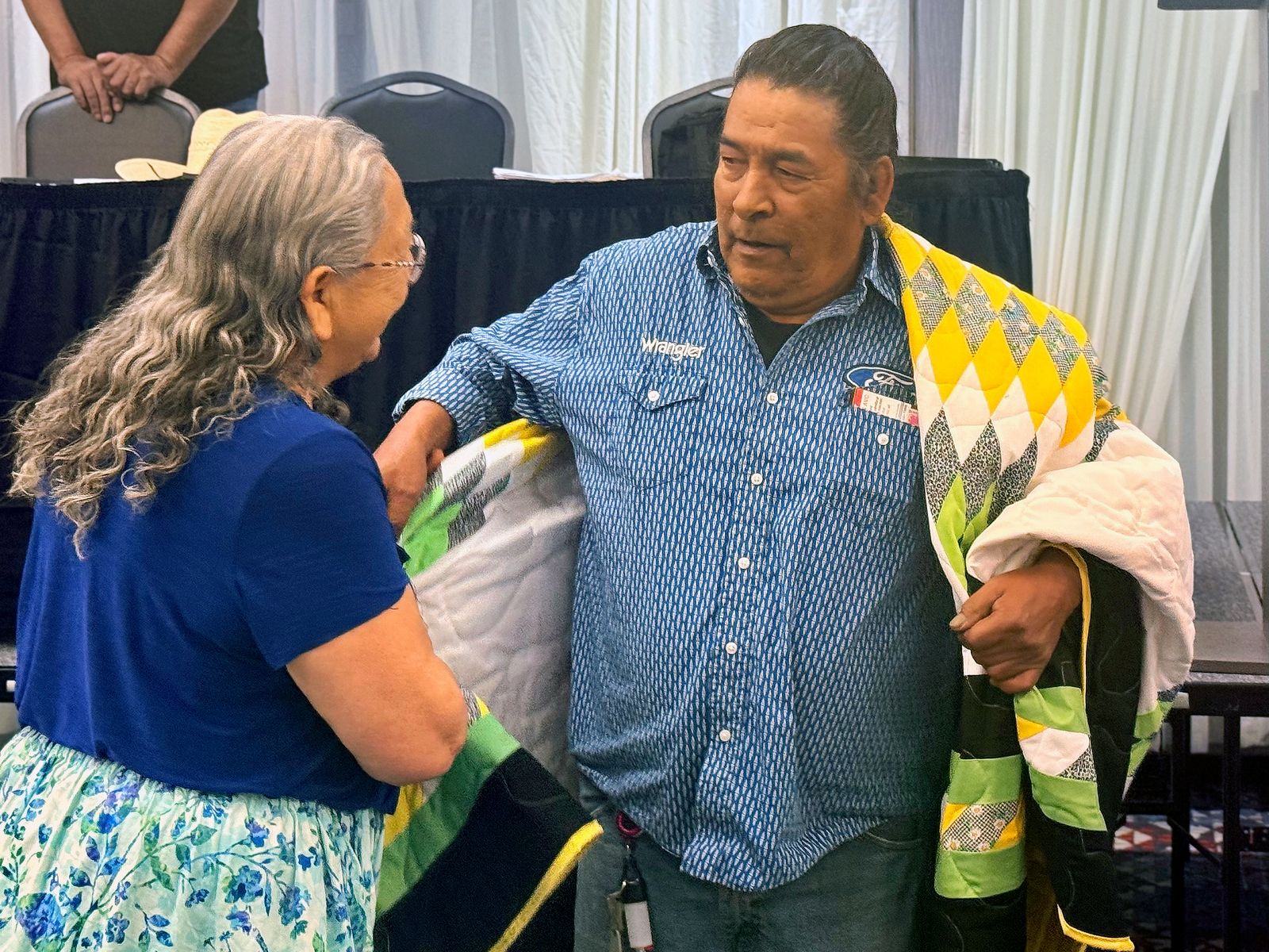Clayton Waditaka, Wahpaton Dakota, Saskatchewan, Canada, is gifted a starquilt in recognition of his participation in the Battle of the Little Bighorn planning activities. In the mid 1800s thousands of Dakota and Lakota crossed the border to Canada to live as the buffalo herds became nearly extinct in the United States.