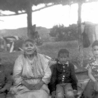 The author’s father, Carlin Rave Sr., far right, sits with his great-grandmother, Grows in Day, also known as Lucy Poor Buffalo, circa 1950. She went with her mother to search for her older brother Bear With Horns, after the Battle of the Little Bighorn.