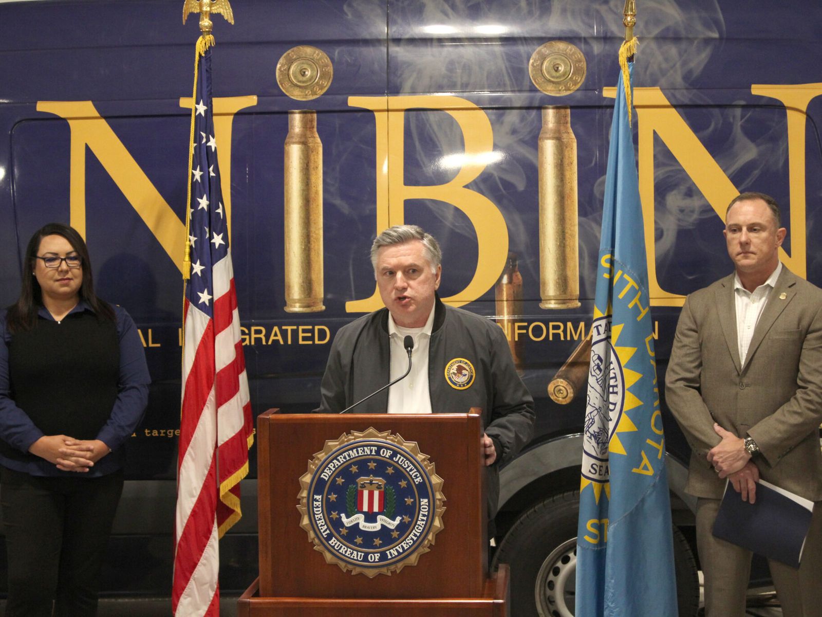 Ron Parsons, center, U.S. attorney for the District of South Dakota, speaks on June 16, 2026, in Rapid City, South Dakota, with Jessica Four Bear, left, attorney general for the Oglala Sioux Tribe, and Christopher Dotson, special agent in charge for the Minneapolis field office of the FBI.