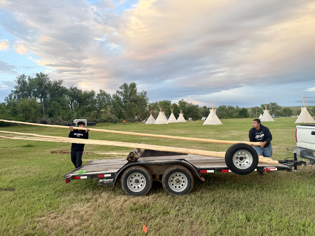 William Pine and Samual Monroy setting up teepees at the northern Cheyenne camp