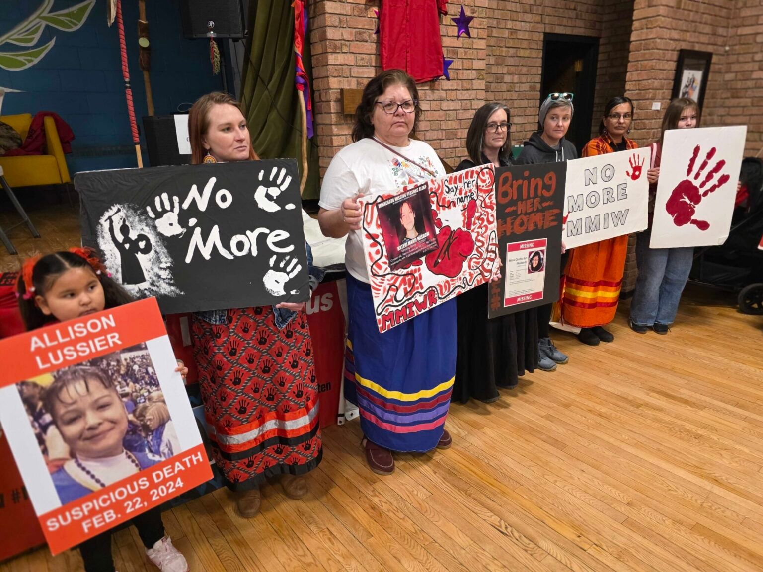 Friends and family members hold posters of loved ones at the 11th annual Memorial March for Missing and Murdered Indigenous Women and Relatives (MMIWR), hosted by the Native Lives Matter Coalition in Duluth, Minn., in February. A new report found American Indian and Alaska Native survivors of violence say reductions in federal funding have led to over 1,000 unmet requests for help.