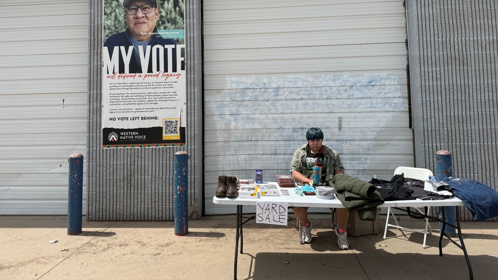 Persais Plenty Hawk sits outside a food panty on the Northern Cheyenne Reservation selling sundry items, May 20, 2026.