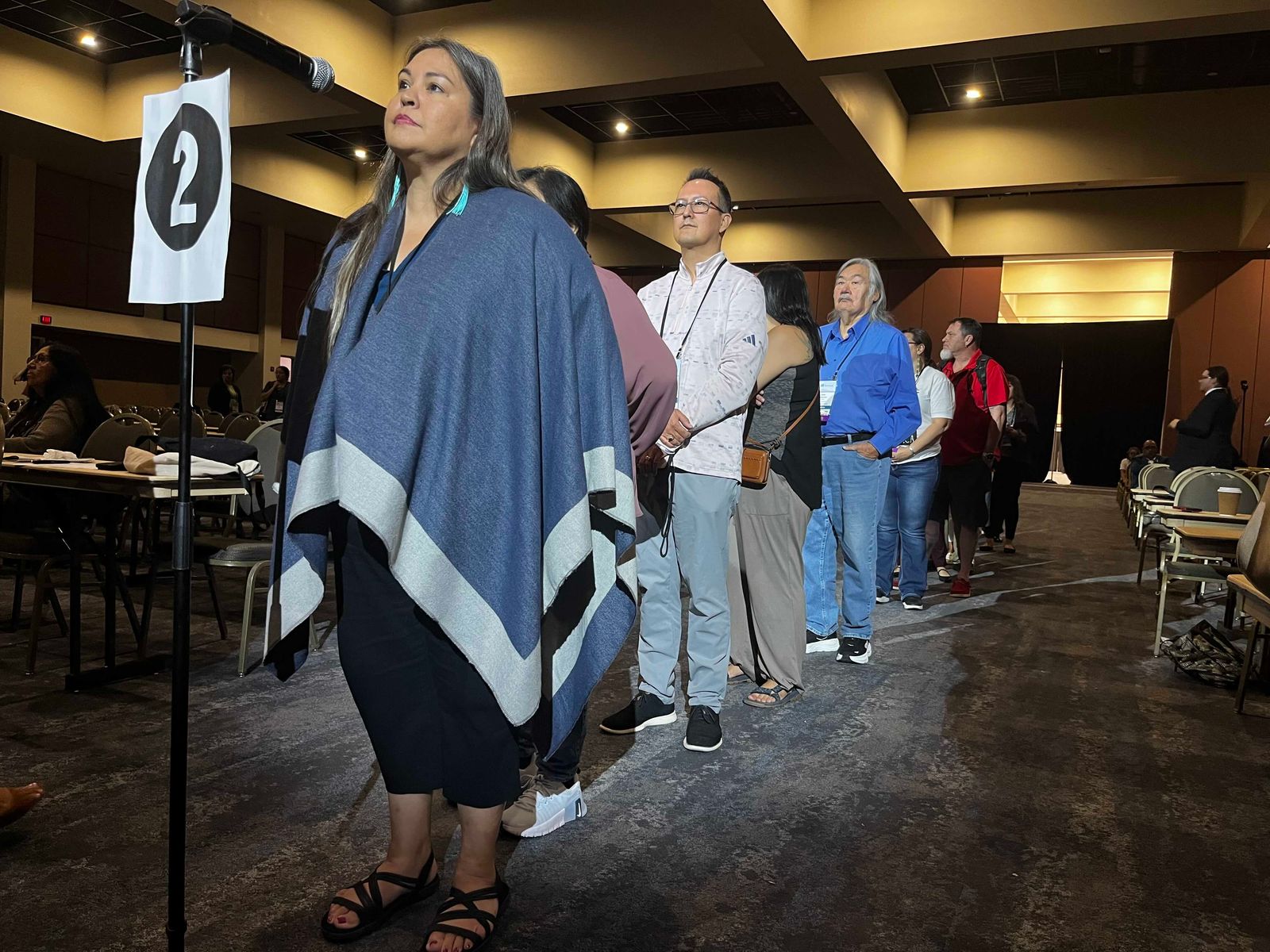Tribal leaders line up for a voice vote on a parliamentary order to end a matter of business before the National Congress of American Indians on the final day of its 83rd annual convention in Palm Springs, California.