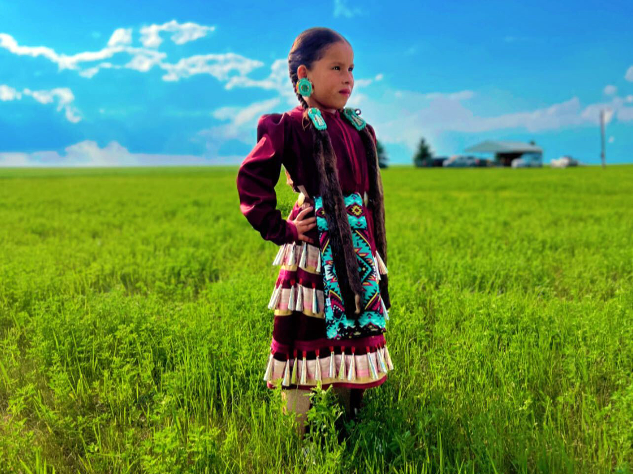 Six-year-old WiCante Mato Zaya WalkingEagle (Red Bear Heart Woman), enrolled in Spirit Lake Nation, wears jingle dress regalia as she makes her way to the Santee Lucky Mound Celebration, Parshall, North Dakota, Sunday, June 22, 2025. (Buffalo's Fire/Castle Fox)
