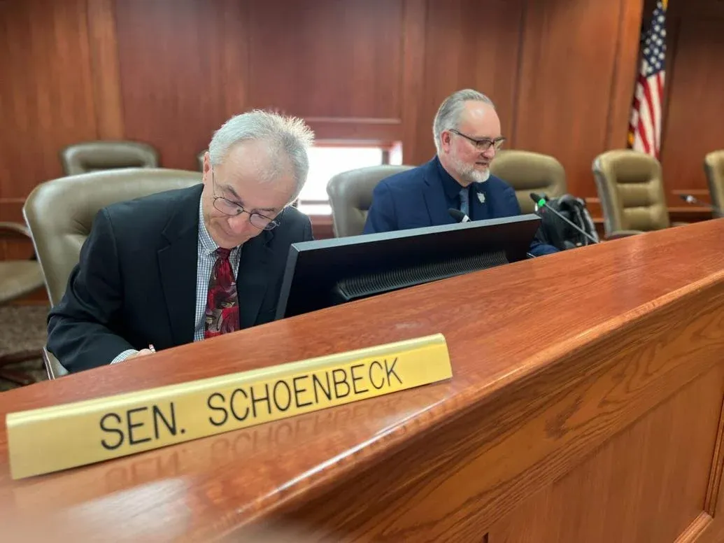 South Dakota state Sens. Lee Schoenbeck, left, a Watertown Republican, and Reynold Nesiba, a Sioux Falls Democrat, attend a committee hearing during the 2023 legislative session. (Joshua Haiar/SD Searchlight).
