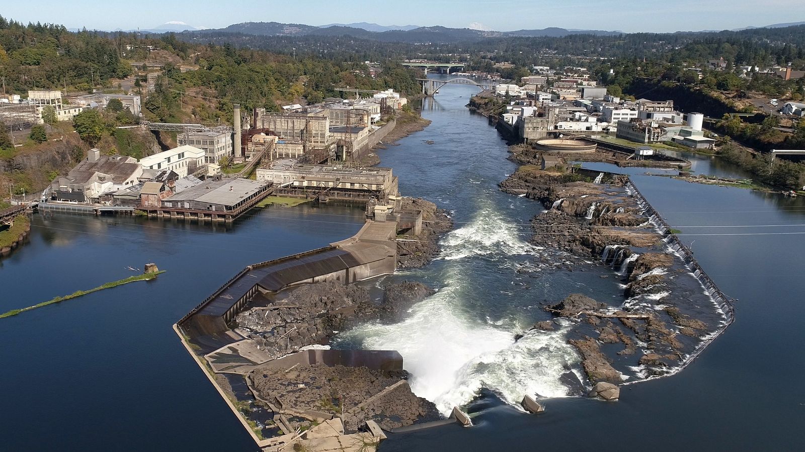 An aerial view of Willamette Falls and the former Blue Heron paper mill. The Confederated Tribes of Grand Ronde marked the beginning of on-site work at the mill on Tues., Sept. 21, 2021. Demolition of one of the mill's buildings was started. The tribes acquired the property in 2019 and plans on restoring the site ecologically while also creating mixed-use development and public gathering spaces.