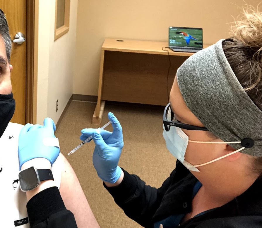 A health worker at the Ko-Kwel Wellness Center in Eugene, Oregon, administers a vaccine, March 10, 2021. / Photo credit: Brian Bull