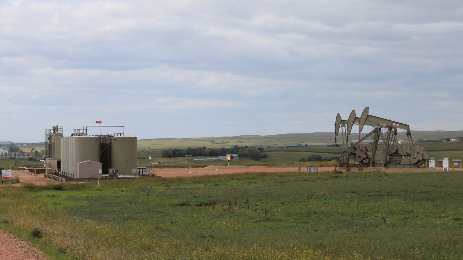 Three pumpjacks and flaring on the Fort Berthold Reservation, North Dakota, Friday, Aug. 22, 2025. (Gabrielle Nelson/Buffalo’s Fire)
