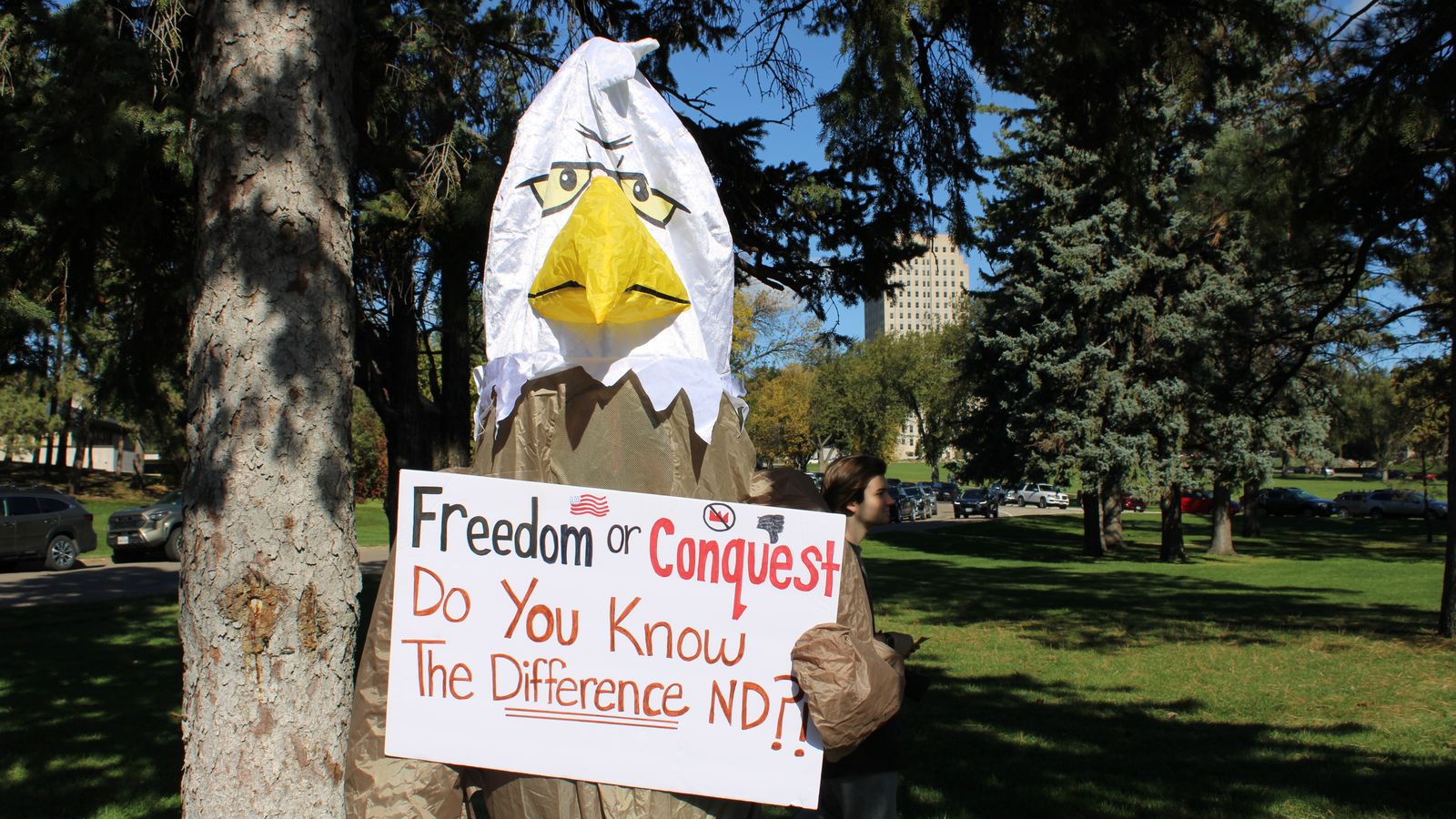 Standing Rock Sioux Tribe citizen Cheryl Kary, executive director of the Sacred Pipe Resource Center, protested in an eagle costume at the “No Kings” rally, Bismarck, North Dakota, Saturday, Oct. 18, 2025. (Buffalo’s Fire/Gabrielle Nelson)