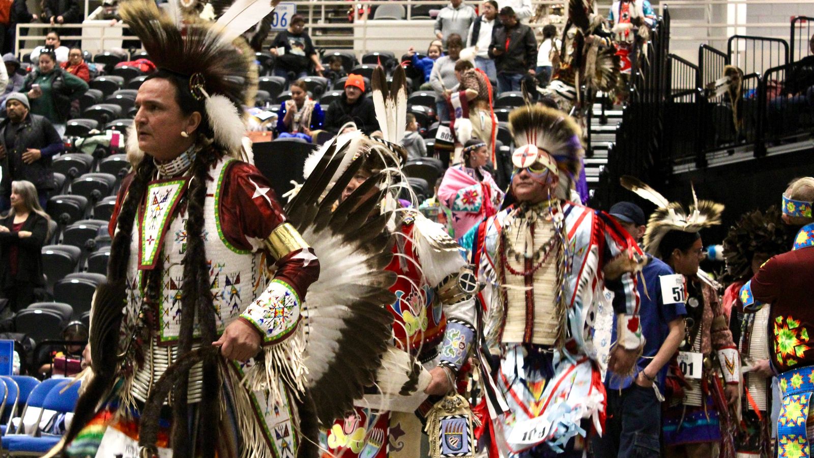 Richard Street, Crow, Sioux and Muscogee, walks into the powwow circle during the second grand entry, Bismarck Event Center, North Dakota