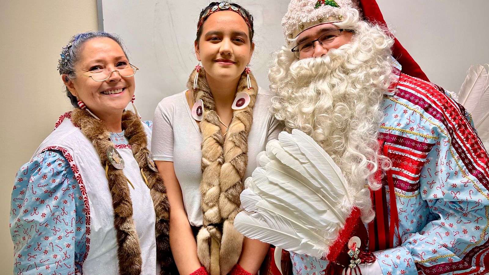Mrs. Crystal Claus, Peppermint the Elf and Solte Santa visit the Chifin Native Youth Center in Springfield, Oregon, Sunday, Dec. 14, 2025. They are portrayed by Colleen Payne, Qalch’ema Friedlander and Jerry Payne. (Buffalo’s Fire/Brian Bull)