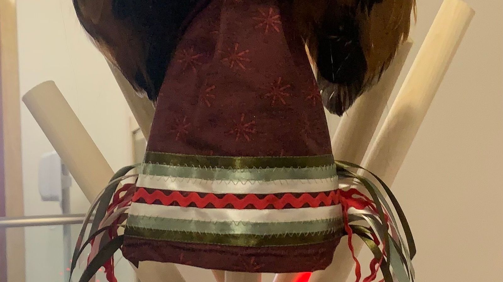 A Native angel wearing Christmas colored dentalium earrings and a ribbon skirt tops the MMIP Christmas tree, Bismarck, North Dakota, Monday, Dec. 15, 2025. (Buffalo’s Fire/Jolan Kruse)