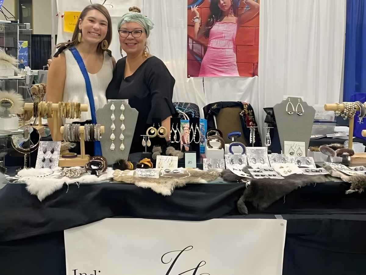 Tlingit artists Naats Tla’a and Shaax’Saani stand behind their booth at the Alaska Native Customary Art Fair at the Alaska Federation of Natives convention in Anchorage, Alaska, Saturday, Oct. 18, 2025. (Photo courtesy of Shaax'Saani)