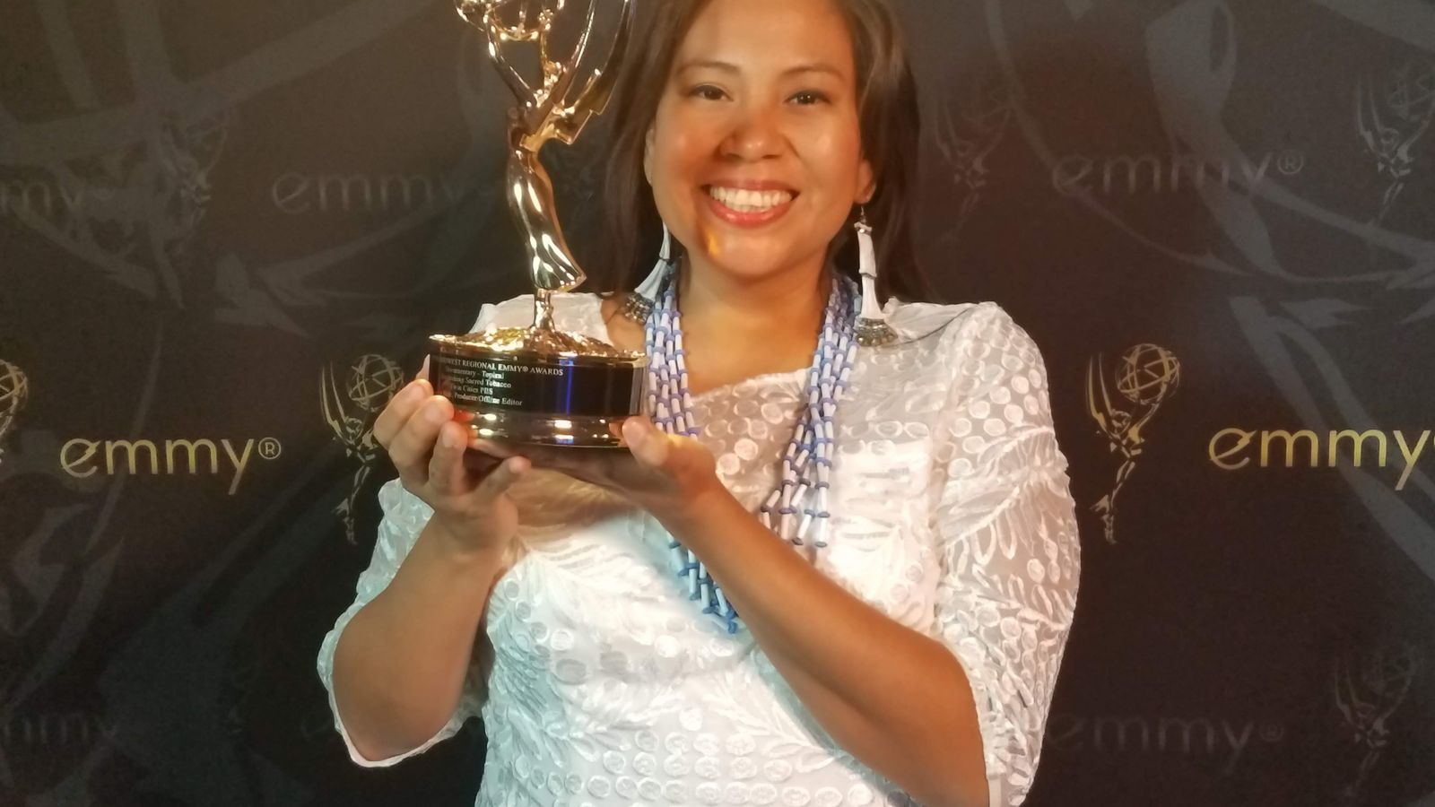 Leya Hale holds up her regional Emmy for “Reclaiming Sacred Tobacco,” which won Best Topical Documentary at the Upper Midwest Emmy Awards, Bloomington, Minnesota, Saturday, Oct. 7, 2017. (Photo courtesy Leya Hale)