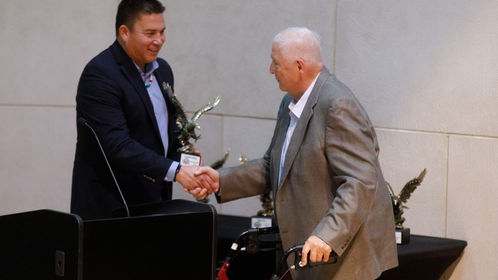 Thomas Fredericks, a retired tribal law attorney, receives a leadership award from Indian Affairs Commission Executive Director Brad Hawk during the North Dakota Native American Hall of Honor induction ceremony on Nov. 15, 2024. Fredericks is a member of the Mandan, Hidatsa and Arikara Nation. (Kyle Martin/For the North Dakota Monitor)