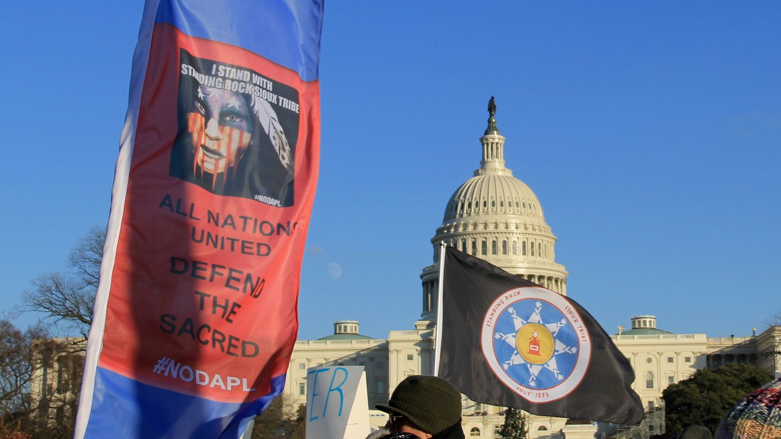 Beyond NoDAPL March on Washington, DC. Native American flag and banner at US Capitol. Dec. 8, 2016.