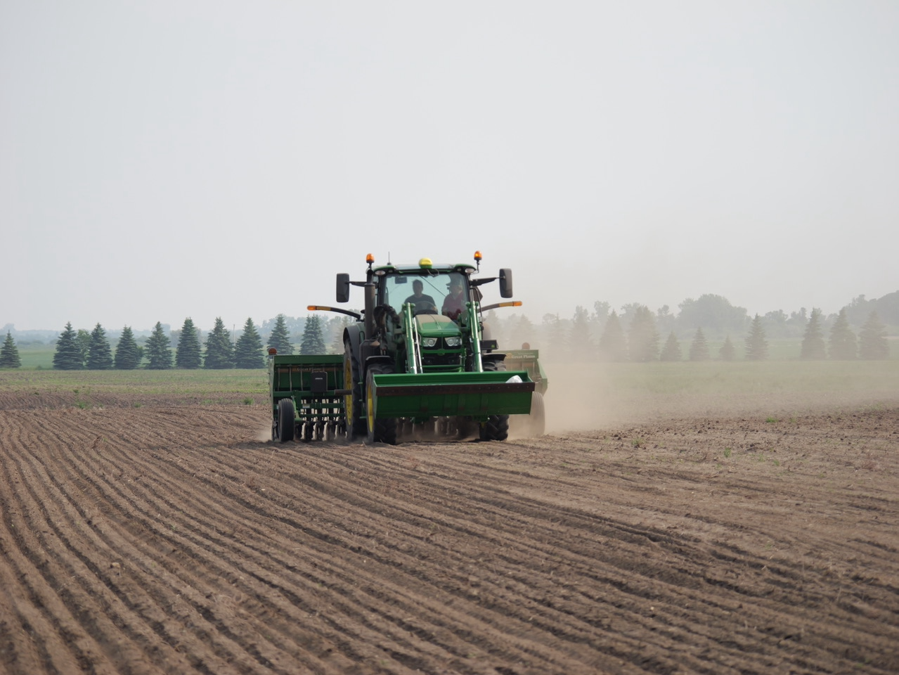 A crew from the Walsh County conservation district plants pasture grass and cover crops in June, 2023.