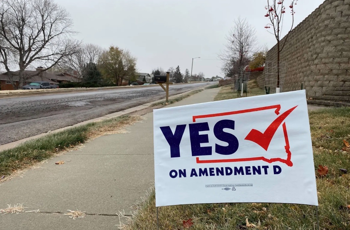 A sign in Rapid City, South Dakota, encourages people to vote in favor of Amendment D, a measure to expand Medicaid eligibility for state residents. (Arielle Zionts/KHN)