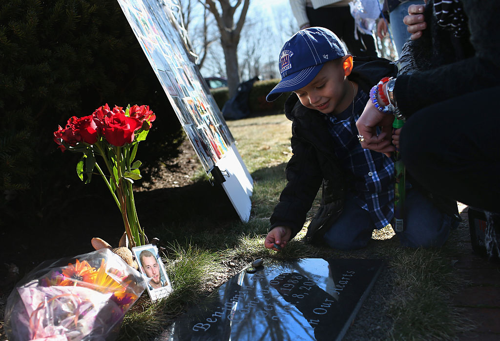 PLANTSVILLE, CT - MARCH 06: Cameron Comparone, 2 1/2 places a stone on the grave of his father Benjamin Comparone, 27, as friends and family gathered on March 6, 2016 in Plantsville, Connecticut to commemorate the first anniversary of Benjamin's death from heroin overdose. The nationwide heroin epidemic has overwhelmed many small towns and suburban communities, with heroin overdose deaths quadrupling, according to the Centers of Disease Control. The victims' families, many of them facing stigma themselves, are increasingly going public to lobby for greater access to recovery programs and bring awareness of addiciton as a disease, not a moral failing. The CDC says that of first time heroin users, some 90 percent are white and 75 percent had used prescription pain killers before turning to heroin. (Photo by John Moore/Getty Images)